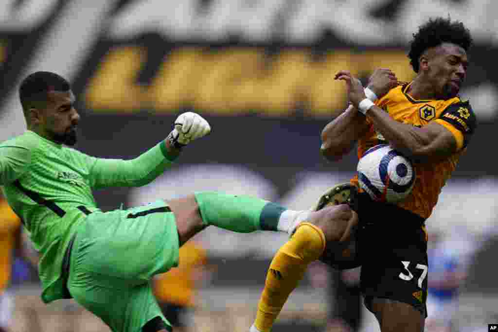 Wolverhampton Wanderers&#39; Adama Traore is hit by Brighton&#39;s goalkeeper Robert Sanchez during the English Premier League soccer match between Wolverhampton Wanderers and Brighton &amp; Hove Albion at the Molineux Stadium in Wolverhampton, England.