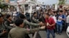 FILE PHOTO - Riot police officers stop journalists from entering a blocked main street near the Cambodia National Rescue Party (CNRP) headquarters, on the outskirts of Phnom Penh, Cambodia, Monday, May 30, 2016. 