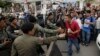 Riot police officers stop journalists from entering a blocked main street near the Cambodia National Rescue Party (CNRP) headquarters, on the outskirts of Phnom Penh, Cambodia, Monday, May 30, 2016. Police in Cambodia blocked an opposition protest march o