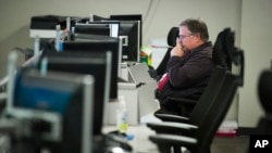 FILE - A workers sits at a computer at the Department of Homeland Security's National Cybersecurity and Communications Integration Center (NCCIC) in Arlington, Va., Aug. 22, 2018. 