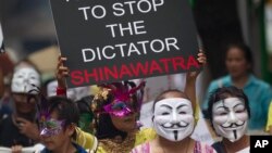 Masked Thai protesters holding placards and banners stage an anti-government rally in Bangkok, May 31, 2013. 