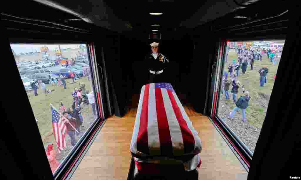 The train carrying the casket of former President George H.W. Bush passes through Magnolia, Texas, Dec. 6, 2018, along the route from Spring to College Station, Texas. The 41st president who served in the office from 1989 to 1993, died Nov. 30 at the age of 94.