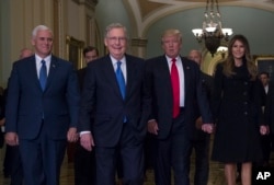 President-elect Donald Trump, his wife Melania, Vice President-elect Mike Pence and Senate Majority Leader Mitch McConnell of Kentucky walk on Capitol Hill in Washington, Nov. 10, 2016.