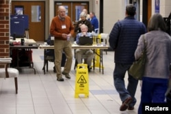 Voters arrive to cast their ballots in the U.S. Republican presidential primary at a polling station at Dreher High School in Columbia, S.C., Feb. 20, 2016.