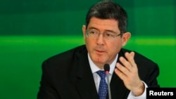 FILE - Joaquim Levy gestures during a news conference in Brasilia, Nov. 27, 2014. 