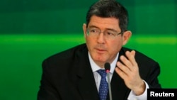 FILE - Brazil's incoming finance minister, banker Joaquim Levy gestures during a news conference in Brasilia, Nov. 27, 2014. 
