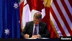 New Zealand's Minister for Trade and Export Growth David Parker signs the Trans-Pacific Partnership trade deal, in Santiago, Chile, March 8, 2018.