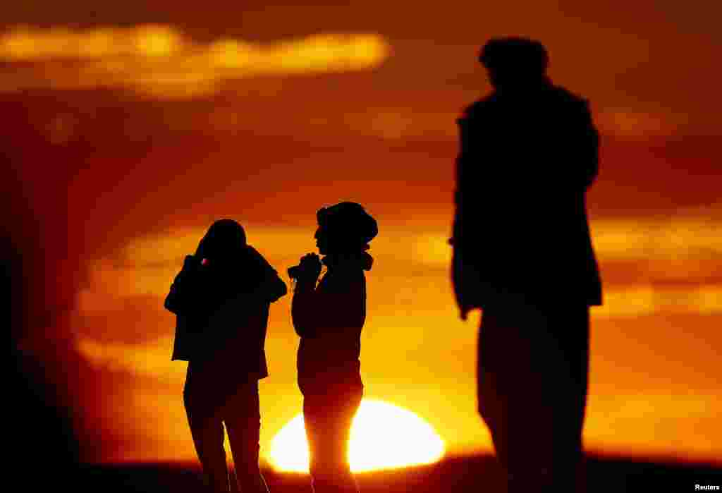 Turkish Kurds watch the Syrian town of Kobani from near the Mursitpinar border crossing, on the Turkish-Syrian border in the southeastern town of Suruc. 