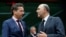 Eurogroup chairman Jeroen Dijsselbloem (L) talks to European Commissioner for economics, taxation and customs Pierre Moscovici (R) during an eurozone finance ministers meeting in Brussels, Jan. 26, 2015. 