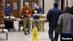 Voters arrive to cast their ballots in the U.S. Republican presidential primary at a polling station at Dreher High School in Columbia, S.C., Feb. 20, 2016. 