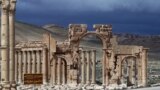 Syrian citizens walking in the ancient oasis city of Palmyra, 215 kilometres northeast of Damascus. 