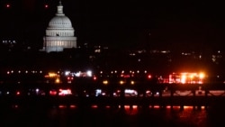 Emergency vehicles stage at Ronald Reagan Washington National Airport, Jan. 29, 2025, in Arlington, Va. The U.S. Capitol is seen across the Potomac River in Washington.