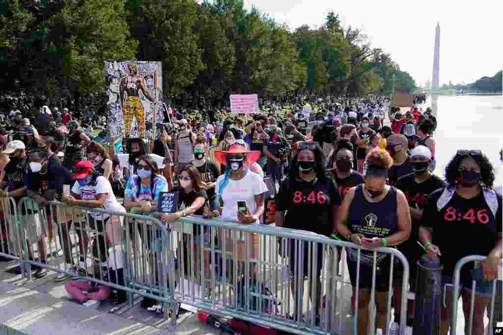 People attend the March on Washington, Aug. 28, 2020, at the Lincoln Memorial in Washington, on the 57th anniversary of the Rev. Martin Luther King Jr.&#39;s &quot;I Have A Dream&quot; speech. 