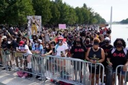 People attend the March on Washington, Aug. 28, 2020, at the Lincoln Memorial in Washington, on the 57th anniversary of the Rev. Martin Luther King Jr.'s "I Have A Dream" speech.