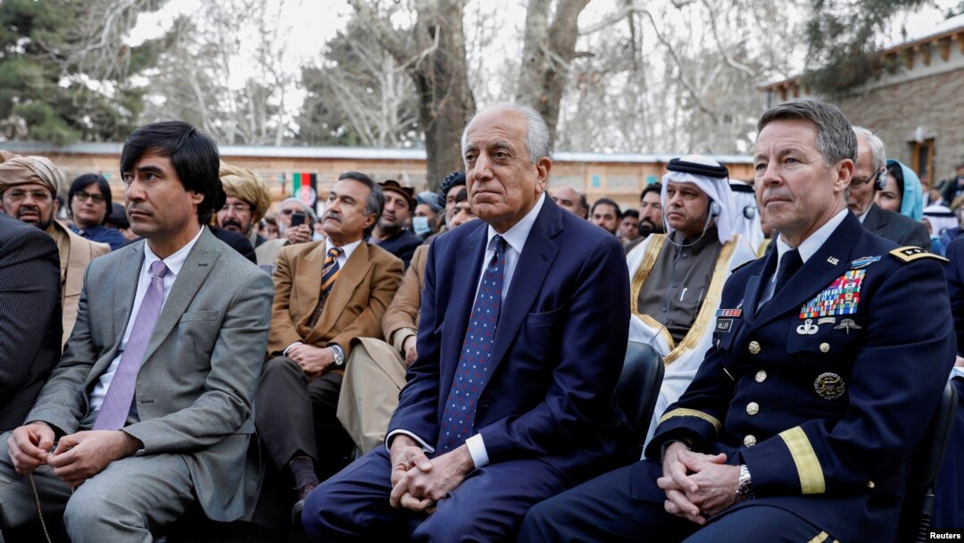 FILE - U.S. envoy for peace in Afghanistan Zalmay Khalilzad (C) and U.S. Army General Scott Miller, commander of NATO's Resolute Support Mission, attend President Ashraf Ghani's inauguration, in Kabul, March 9, 2020.