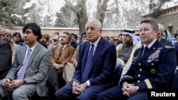 FILE - U.S. envoy for peace in Afghanistan Zalmay Khalilzad (C) and U.S. Army General Scott Miller, commander of NATO's Resolute Support Mission, attend President Ashraf Ghani's inauguration, in Kabul, March 9, 2020.
