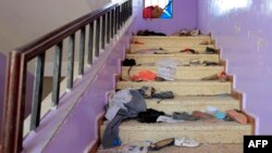 The belongings of Yemeni students are seen scattered on a staircase bearing blood stains at a school in the capital Sanaa on April 7, 2019, following explosions near the school.