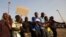 Striking platinum miners are seen gathered at Lonmin's Marikana mine in South Africa August 29, 2012.
