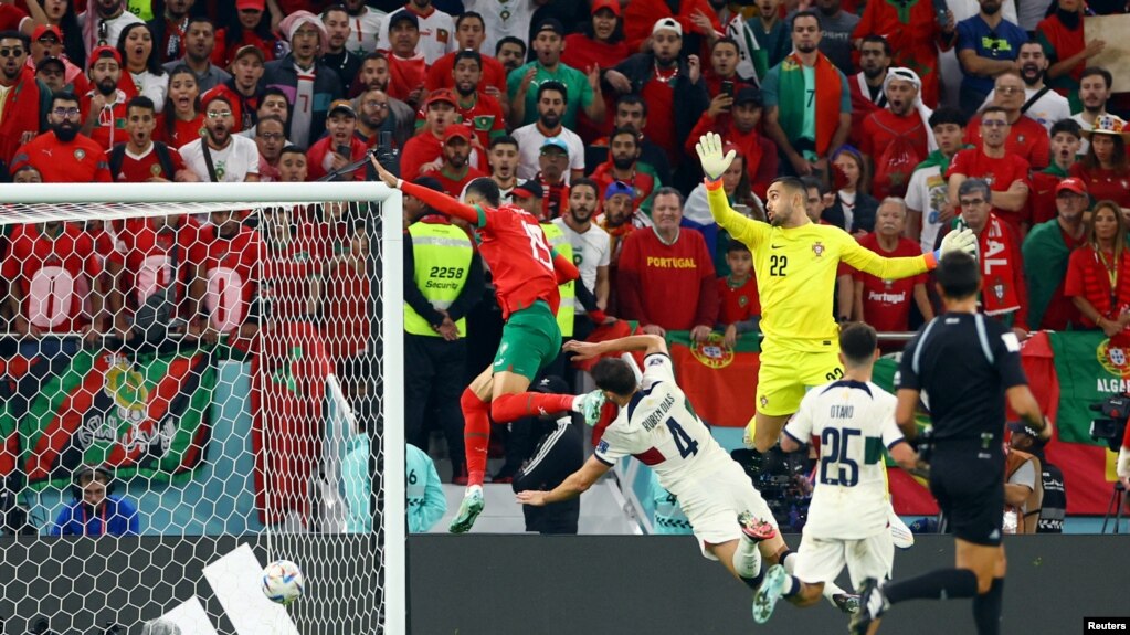 Morocco's Youssef En-Nesyri scores the opening goal against Portugal at the 2022 FIFA World Cup