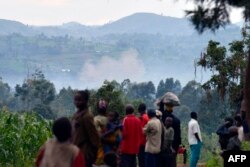 Penduduk Rutshuru menyaksikan pengerahan senjata berat oleh pasukan FARDC melawan pemberontak M23 di Gunung Mbuzi pada 3 November 2013. (Foto: AFP)