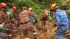 In this photo released by Korporat JBPM, rescuers work during a rescue and evacuation operation following a landslide at a campsite in Batang Kali, Selangor state, on the outskirts of Kuala Lumpur, Malaysia, Dec. 16, 2022.