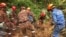 In this photo released by Korporat JBPM, rescuers work during a rescue and evacuation operation following a landslide at a campsite in Batang Kali, Selangor state, on the outskirts of Kuala Lumpur, Malaysia, Dec. 16, 2022.