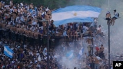 Argentine soccer fans celebrate their team's World Cup victory over France in Buenos Aires, Argentina, Dec. 18, 2022.