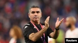 Tunisia's coach Jalel Kadri applauds after beating France 1-0 but facing elimination from the 2022 FIFA World Cup in the group stages