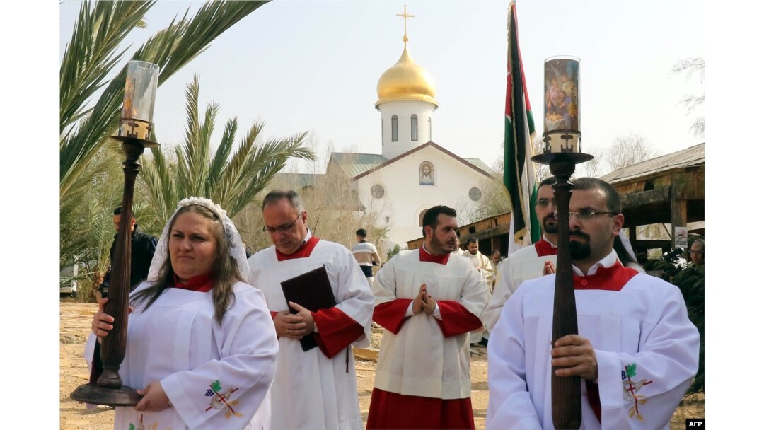 FILE - Christian clerics attend an annual pilgrimage to Bethany beyond the Jordan river, the site where many believe Jesus Christ was baptized, west of the Jordanian capital Amman, Jan. 12, 2018.