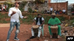 A group of young Mbolé artists gather in a stadium during an improvisation session in the Mvog-Ada district in Yaounde on Nov. 8, 2022.