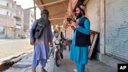 FILE - Taliban fighters patrol in Farah province, southwest of Kabul, Afghanistan, Aug. 11, 2021. Taliban rulers on Dec. 7, 2022, carried out the first public execution of a man charged with murder since returning to power. The execution took place at a stadium in Farah province.