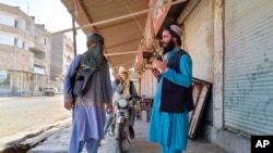 FILE - Taliban fighters patrol in Farah province, southwest of Kabul, Afghanistan, Aug. 11, 2021. Taliban rulers on Dec. 7, 2022, carried out the first public execution of a man charged with murder since returning to power. The execution took place at a stadium in Farah province.
