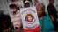 A woman holds a poster showing Colombian-born businessman Alex Saab in a demonstration demanding his release, in Caracas, Venezuela, Dec. 16, 2022. 