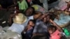 FILE - People displaced by gang war violence in Cite Soleil rest on the streets of Delmas neighborhood after leaving Hugo Chavez Square in Port-au-Prince, Haiti, Nov. 19, 2022.