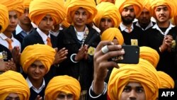 Sikh boys take a selfie during a national level Turban tying event held at the Golden Temple in Amritsar, India.
