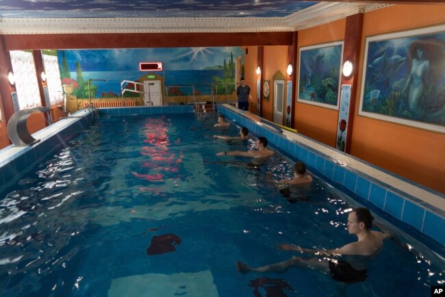 Ukrainian soldier take part in an aquatic therapy session in a hot pool at a rehabilitation center in Kharkiv region, Ukraine, Friday, Dec. 30, 2022. (AP Photo/Vasilisa Stepanenko)