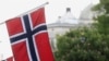 FILE - Norwegian flags flutter at Karl Johans street in Oslo, Norway, May 31, 2017. An unidentified man, described only as a 'well known' suspect, was arrested Monday at Oslo's Gardermoen Airport upon returning from a trip to China. 