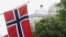 FILE - Norwegian flags flutter at Karl Johans street in Oslo, Norway, May 31, 2017. An unidentified man, described only as a 'well known' suspect, was arrested Monday at Oslo's Gardermoen Airport upon returning from a trip to China. 