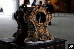 A damaged 17th-century clock stands on display at Planalto Palace after the storming of public buildings by supporters of former President Jair Bolsonaro in Brasilia, Brazil, Jan. 11, 2023.