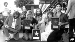 FILE - Members of the recording group Fleetwood Mac pose with their plaques in front of their star on Hollywood Boulevard's Walk of Fame, Ca., Oct. 10, 1979. The musicians from left are, John McVie, Christine McVie, Mick Fleetwood, Stevie Nicks, and Lindsey Buckingham.