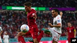 Denmark's Joakim Maehle, left, vies for the ball with Tunisia's Wajdi Kechrida during the World Cup group D soccer match in Al Rayyan, Qatar, Nov. 22, 2022.