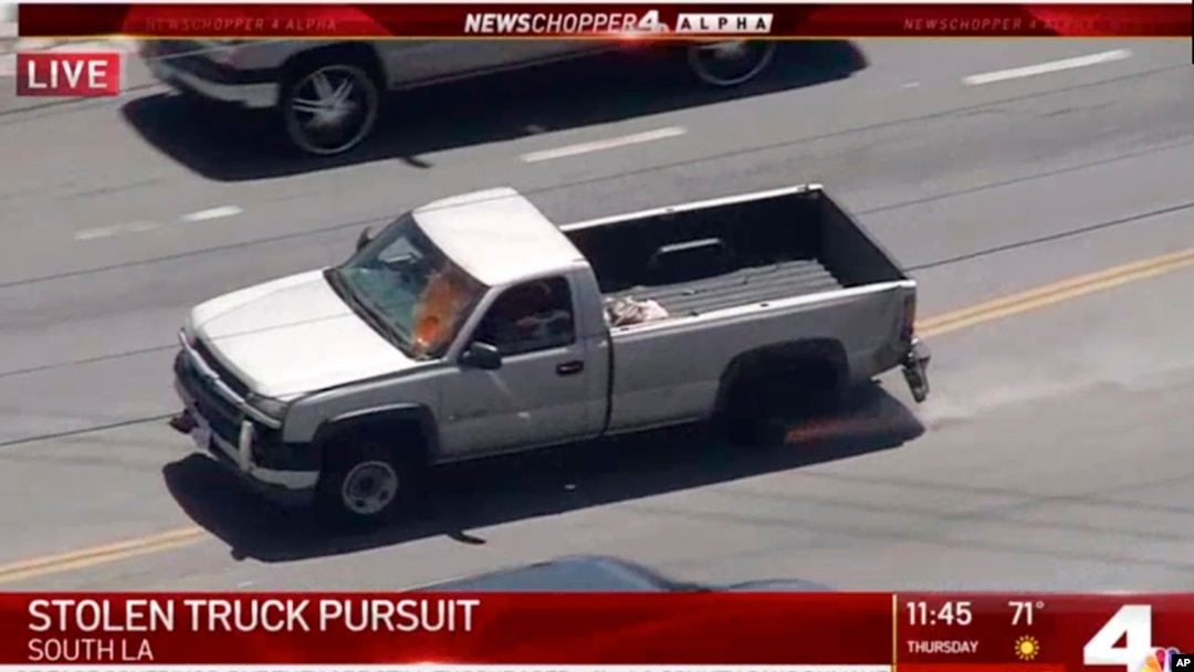 FILE - In this photo from video provided by KNBC-TV a pickup truck that had been reported stolen is pursued by police on Southern California streets and freeways, May 22, 2020.