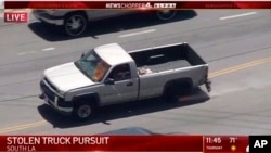 FILE - In this photo from video provided by KNBC-TV a pickup truck that had been reported stolen is pursued by police on Southern California streets and freeways, May 22, 2020.