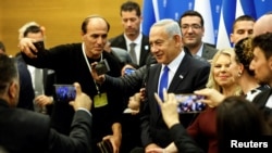 FILE- Israeli Prime Minister Benjamin Netanyahu attends a toast after the new government is sworn in at the parliament, in Jerusalem, Dec. 29, 2022.