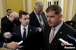 U.S. Secretary of Labor Marty Walsh and Transportation Secretary Pete Buttigieg speak with members of the media about railroad negotiations, on Capitol Hill in Washington, Dec. 1, 2022.