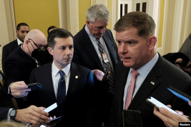 U.S. Secretary of Labor Marty Walsh and Transportation Secretary Pete Buttigieg speak with members of the media about railroad negotiations, on Capitol Hill in Washington, Dec. 1, 2022.