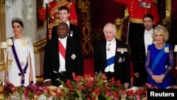FILE: The Princess of Wales, President Cyril Ramaphosa of South Africa, King Charles III and the Queen Consort, stand during the State Banquet held at Buckingham Palace, London, during the State Visit to the UK by the South African president, Nov. 22, 2022.