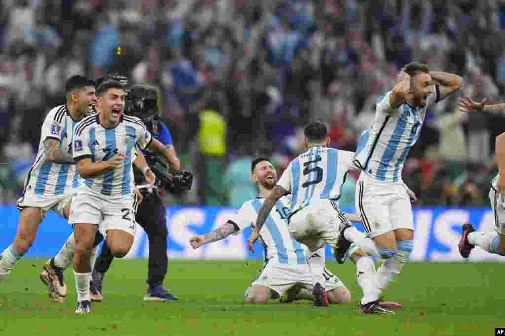 Argentinian players celebrate after winning penalty shootout during the World Cup final soccer match between Argentina and France at the Lusail Stadium in Lusail, Qatar.