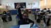 FILE - Students attend a class at a primary school, as schools reopen amid COVID-19 outbreak, in Santiago, Chile, March 1, 2021.