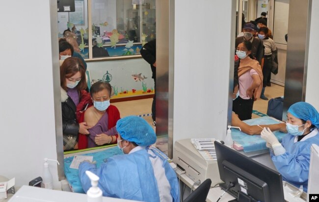 Elderly residents gets vaccinated against COVID-19 at a community health center in Nantong in eastern China's Jiangsu province on Dec. 9, 2022. (Chinatopix Via AP)